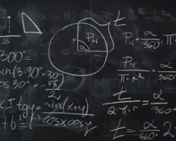 www.kaboompics.com Trigonometric equations and geometric diagrams drawn on a classroom blackboard.